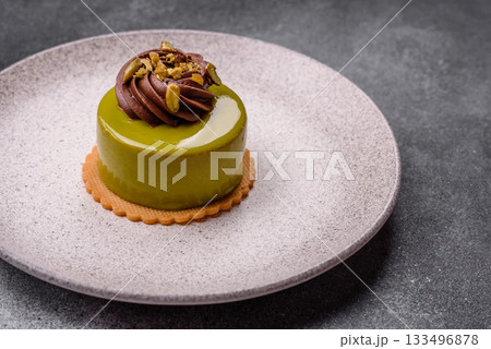 Pistachio cake or tart topped with green mousse with nuts and fruit filling. Pistachio pie Pistachio cake or tart topped with green mousse with nuts and fruit filling. Pistachio pie 133496878