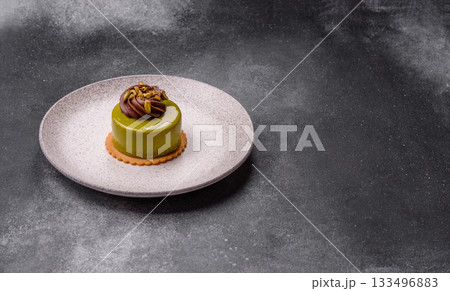 Pistachio cake or tart topped with green mousse with nuts and fruit filling. Pistachio pie Pistachio cake or tart topped with green mousse with nuts and fruit filling. Pistachio pie 133496883