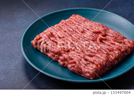 Raw ground beef or pork, fresh meat for burgers or other dishes. Raw beef minced meat Raw ground beef or pork, fresh meat for burgers or other dishes. Raw beef minced meat 133497004