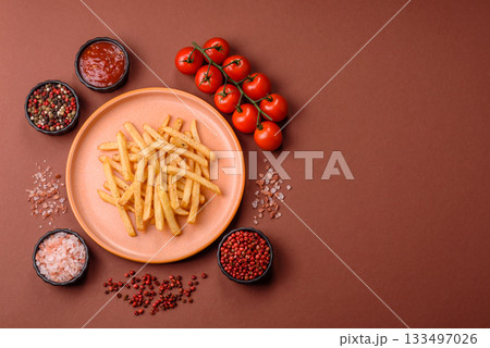 Crispy French fries with sauce, fast food, snack or chips. French fries, takeaway food Crispy French fries with sauce, fast food, snack or chips. French fries, takeaway food 133497026