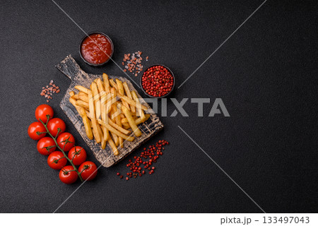 Crispy French fries with sauce, fast food, snack or chips. French fries, takeaway food 133497043