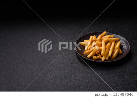 Crispy French fries with sauce, fast food, snack or chips. French fries, takeaway food 133497046