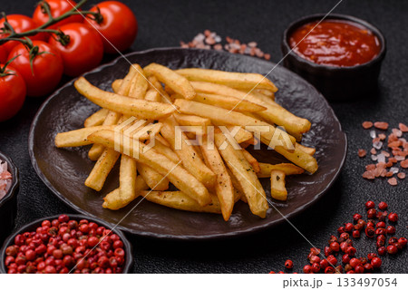 Crispy French fries with sauce, fast food, snack or chips. French fries, takeaway food Crispy French fries with sauce, fast food, snack or chips. French fries, takeaway food 133497054