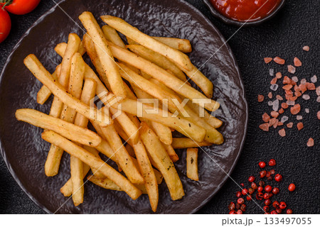 Crispy French fries with sauce, fast food, snack or chips. French fries, takeaway food Crispy French fries with sauce, fast food, snack or chips. French fries, takeaway food 133497055