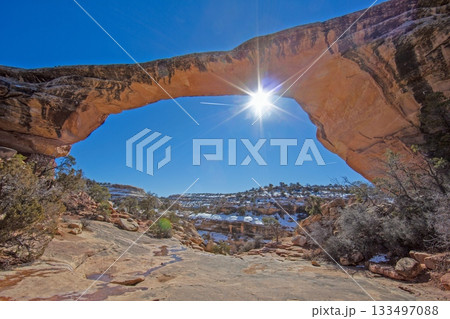 Sunburst through Natural Sandstone Arch in Utah Winter Sunburst through Natural Sandstone Arch in Utah Winter 133497088