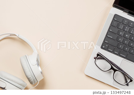 Laptop and stationery on beige workspace, top view with copy space 133497248
