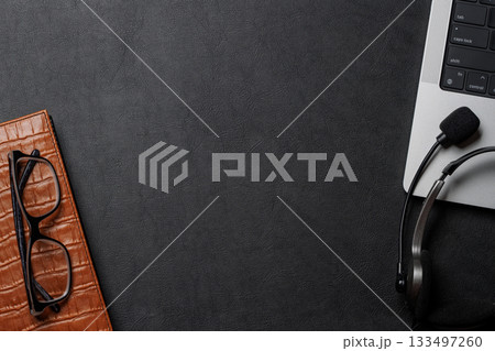 Office supplies and laptop on black leather workspace, top view with copy space 133497260