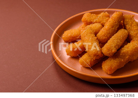 Mozzarella cheese sticks, crispy nutritious fast food. Cheese sticks as food background Mozzarella cheese sticks, crispy nutritious fast food. Cheese sticks as food background 133497368