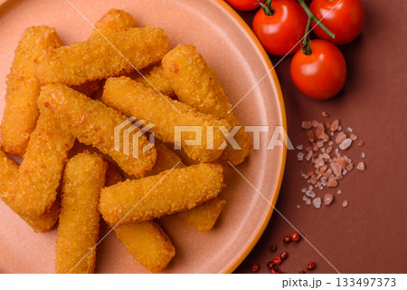 Mozzarella cheese sticks, crispy nutritious fast food. Cheese sticks as food background Mozzarella cheese sticks, crispy nutritious fast food. Cheese sticks as food background 133497373