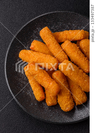 Mozzarella cheese sticks, crispy nutritious fast food. Cheese sticks as food background Mozzarella cheese sticks, crispy nutritious fast food. Cheese sticks as food background 133497387