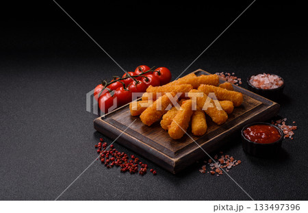 Mozzarella cheese sticks, crispy nutritious fast food. Cheese sticks as food background Mozzarella cheese sticks, crispy nutritious fast food. Cheese sticks as food background 133497396