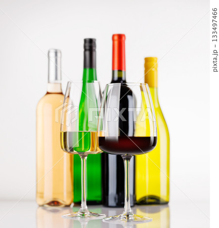 Different wine bottles and glasses on white background Different wine bottles and glasses on white background 133497466