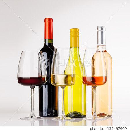 Different wine bottles and glasses on white background Different wine bottles and glasses on white background 133497469