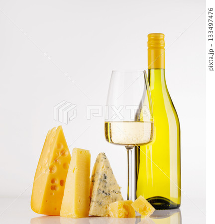 Assorted cheeses and wine on white background 133497476