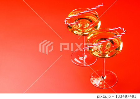 Champagne glasses and candy canes 133497493