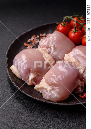 Chicken or turkey raw thigh fillet, skinless and boneless poultry meat. Chicken thigh fillet Chicken or turkey raw thigh fillet, skinless and boneless poultry meat. Chicken thigh fillet 133497513