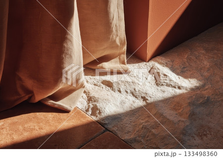 Natural light highlights textured surfaces in a cozy space 133498360