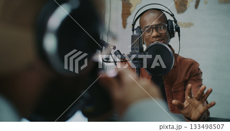 Candid Podcast Conversation Between Two Men in Creative Studio 133498507
