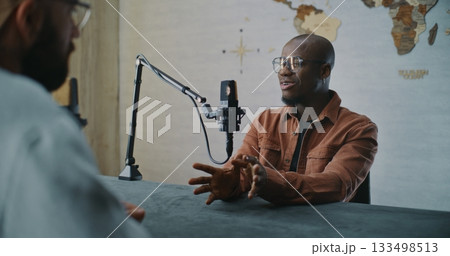 Smiling Podcast Guest Sharing Insights During Relaxed Studio Talk Smiling Podcast Guest Sharing Insights During Relaxed Studio Talk 133498513