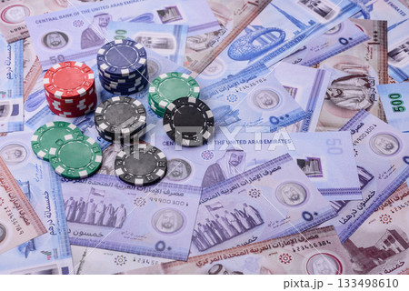 Casino game in the United Arab Emirates, dirham, chips, cards. Gambling in casinos in the Emirates Casino game in the United Arab Emirates, dirham, chips, cards. Gambling in casinos in the Emirates 133498610