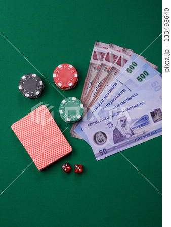 Casino game in the United Arab Emirates, dirham, chips, cards. Gambling in casinos in the Emirates Casino game in the United Arab Emirates, dirham, chips, cards. Gambling in casinos in the Emirates 133498640
