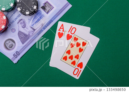 Casino game in the United Arab Emirates, dirham, chips, cards. Gambling in casinos in the Emirates 133498650
