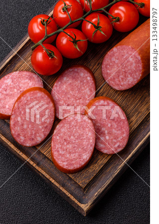 Sliced salami sausage, smoked dry meat as food background. Sliced salami Sliced salami sausage, smoked dry meat as food background. Sliced salami 133498797