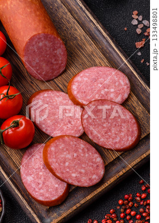 Sliced salami sausage, smoked dry meat as food background. Sliced salami 133498801