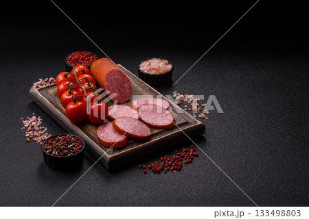 Sliced salami sausage, smoked dry meat as food background. Sliced salami Sliced salami sausage, smoked dry meat as food background. Sliced salami 133498803