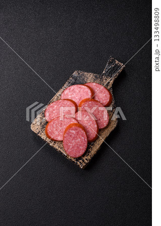 Sliced salami sausage, smoked dry meat as food background. Sliced salami 133498809