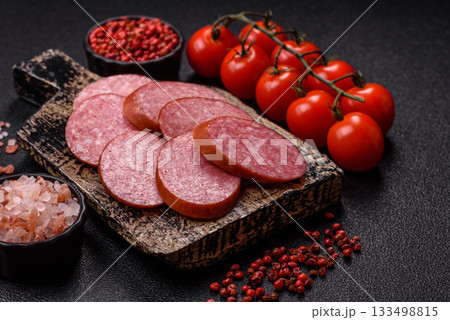 Sliced salami sausage, smoked dry meat as food background. Sliced salami 133498815