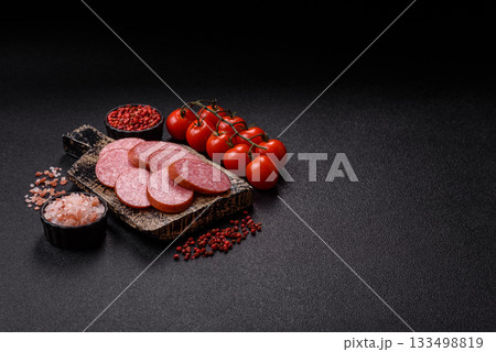 Sliced salami sausage, smoked dry meat as food background. Sliced salami 133498819
