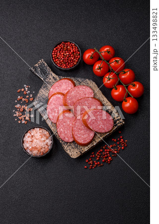 Sliced salami sausage, smoked dry meat as food background. Sliced salami 133498821