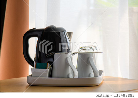 Kettle and tea cup in the living room 133498883