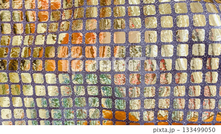 Gold and silver sequin fabric macro background. Shimmering mosaic pattern for luxury party and fashion design 133499050