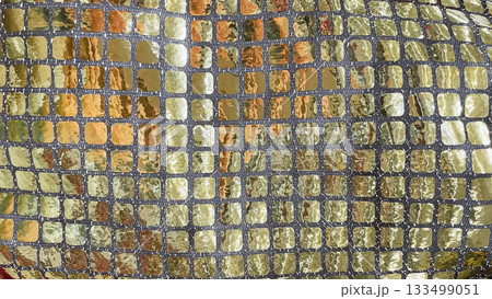 Gold and silver sequin fabric macro background. Shimmering mosaic pattern for luxury party and fashion design 133499051