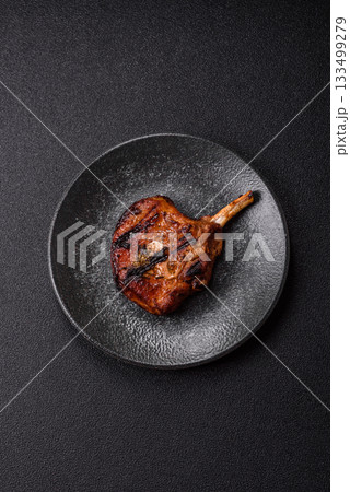 Steak, beef or pork on the bone, meat cooked on the grill with rosemary. Steak on the bone Steak, beef or pork on the bone, meat cooked on the grill with rosemary. Steak on the bone 133499279
