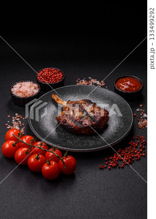 Steak, beef or pork on the bone, meat cooked on the grill with rosemary. Steak on the bone 133499292