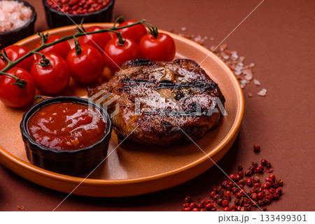 Steak, beef or pork on the bone, meat cooked on the grill with rosemary. Steak on the bone 133499301