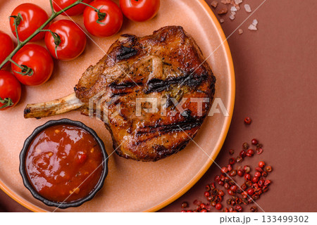 Steak, beef or pork on the bone, meat cooked on the grill with rosemary. Steak on the bone 133499302