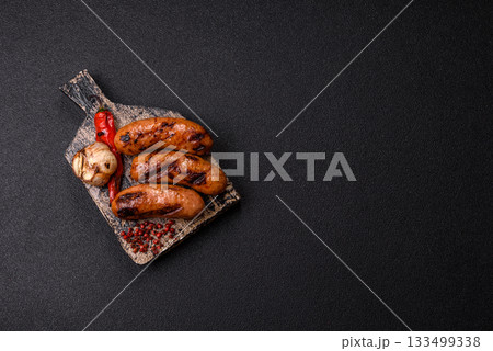 Grilled chicken or beef sausages with sauce and spices. Grilled sausages 133499338
