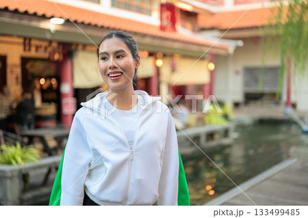 Young Asian Woman in Sporty Casual Outfit Outdoors in Zen Garden Young Asian Woman in Sporty Casual Outfit Outdoors in Zen Garden 133499485