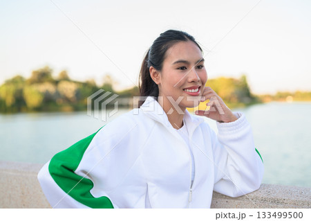 Young Asian Woman in Sporty Casual Outfit Outdoors in Lake Garden 133499500