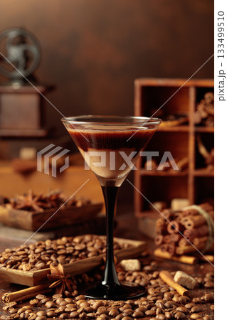 Cream and coffee cocktail on a table with scattered ingredients. 133499510