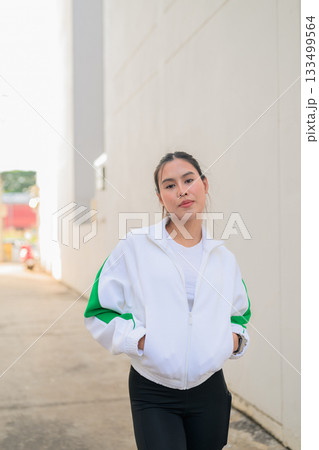 Young Asian Woman in Sporty Casual Outfit Outdoors 133499564