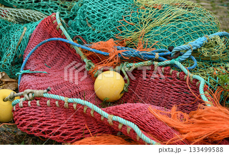 Multicolored green red fishing nets in the port 133499588