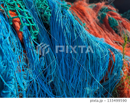 Multicolored orange blue fishing nets in the port 133499590