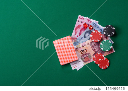 Casino game in the China, yuan money, chips, cards. Gambling in casinos in the China Casino game in the China, yuan money, chips, cards. Gambling in casinos in the China 133499626