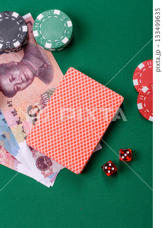 Casino game in the China, yuan money, chips, cards. Gambling in casinos in the China Casino game in the China, yuan money, chips, cards. Gambling in casinos in the China 133499635