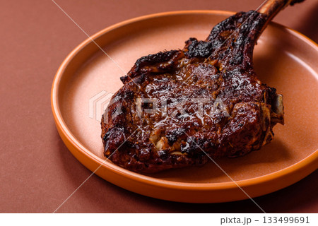 Grilled bone-in meat, beef tomahawk steak, juicy barbecued meat. Tomahawk steak 133499691